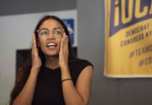 Alexandria Ocasio-Cortez sitting with eyeglasses