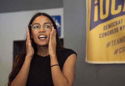 Alexandria Ocasio-Cortez sitting with eyeglasses