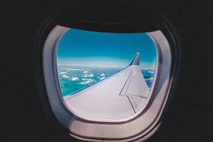 A view from an airplane window with a visible airplane wing