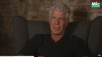 Anthony Bourdain sitting during an interview