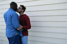 Two men kissing as a PDA moment