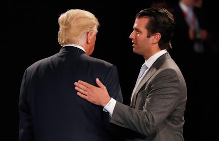 Donald Trump Jr. tapping the back of Donald Trump