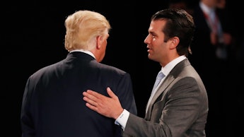 Donald Trump Jr. tapping the back of Donald Trump