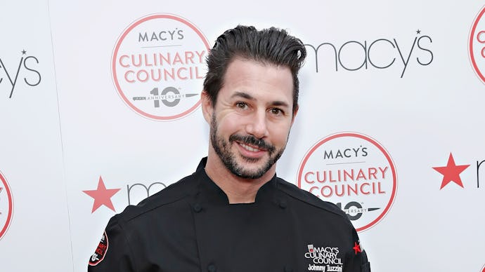Chef Johnny Iuzzini posing in a black kitchen uniform