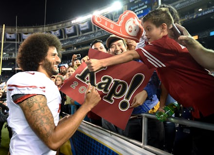 Colin Kaepernick signing a banner for his fans