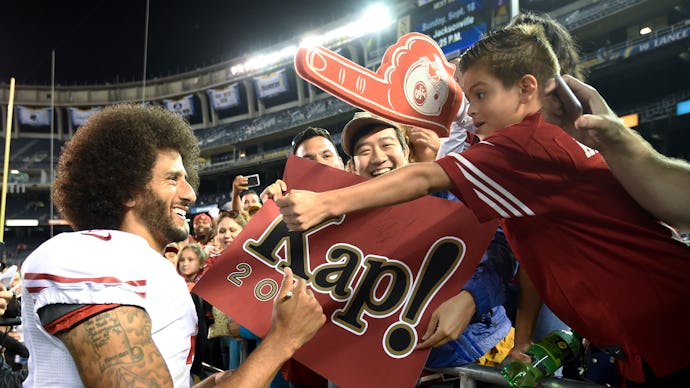 Colin Kaepernick signing a banner for his fans