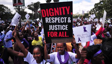 A group of people protesting in the #MyDressMyChoice movement with large posters