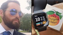 Sam Shields in a suit and sunglasses showing his smart watch after traveling 600 miles on election d...