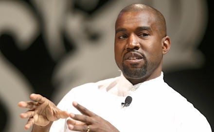 Kanye West in a white shirt talking during an interview