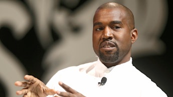 Kanye West in a white shirt talking during an interview