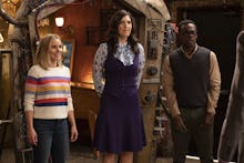 Eleanor, Chidi and Janet standing next to each other in an episode of the good place