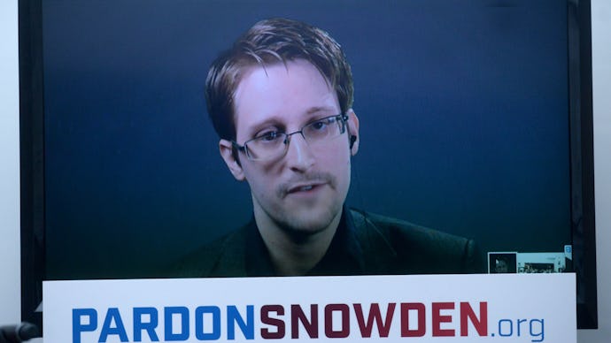 Edward Snowden on a TV screen with a text reading 'PardonSnowden.org' below his face