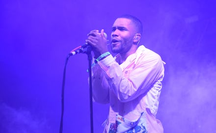 Frank Ocean in a white suit performing on stage