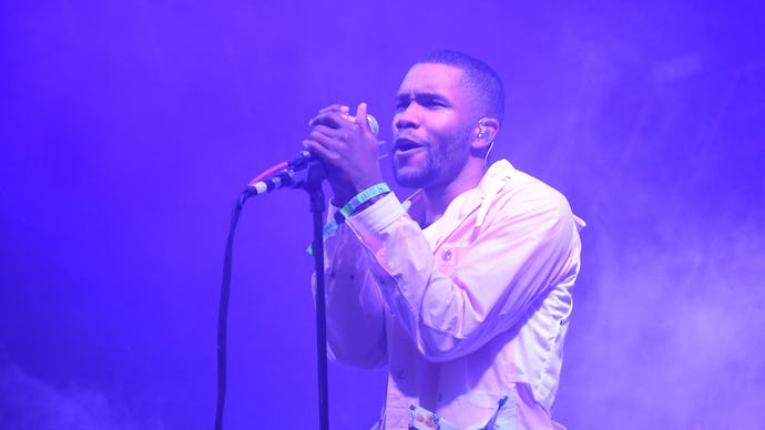 Frank Ocean in a white suit performing on stage