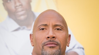 Dwayne Johnson in a black suit, and a white shirt