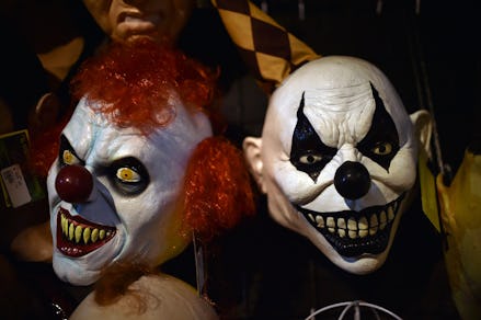 Two men wearing evil clown Halloween masks