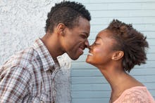 A happy couple smiling at each other and touching their noses together