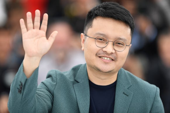 Chinese film director Bi Gan waving with his right hand to audience