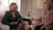 Mary J. Blige reaching out to clasp Hillary Clinton's hand and squeezes it during her singing interv...