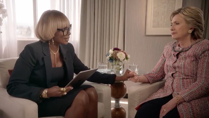 Mary J. Blige reaching out to clasp Hillary Clinton's hand and squeezes it during her singing interv...