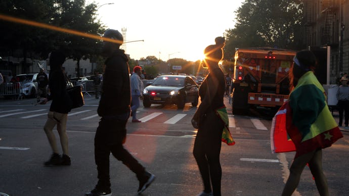 People walking down a street for Ann Marie justice