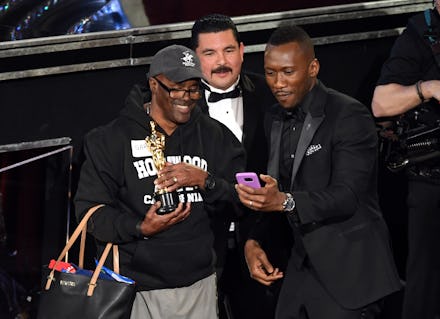 Mahershala Ali taking a selfie with Gary Allan Cole while Guillermo Rodriguez stands in the backgrou...
