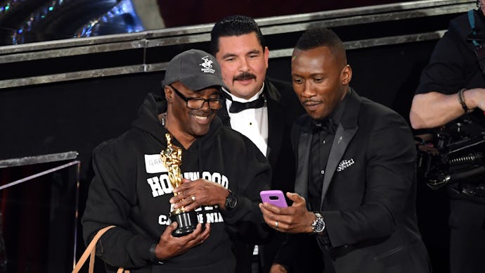 Mahershala Ali taking a selfie with Gary Allan Cole while Guillermo Rodriguez stands in the backgrou...