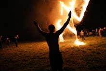 People gathered around a huge fire at a neo-Nazi rally in Georgia