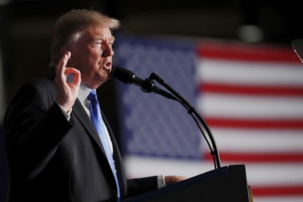 Donald Trump giving a speech with the U.S. flag in the background