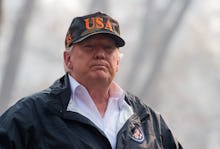 Donald Trump wearing a USA cap looking into the distance