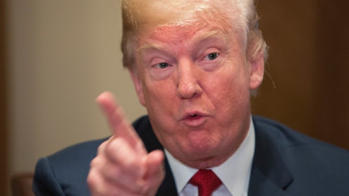 A closeup of Donald Trump speaking, pointing with his index finger 