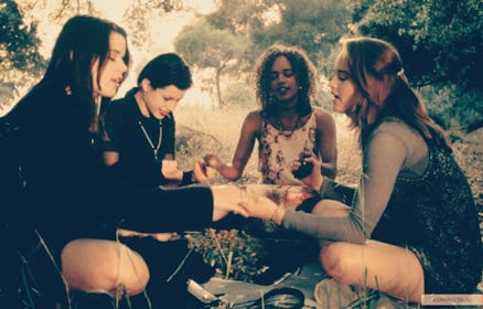 Group of girls sitting in a circle and holding hands
