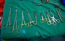 A set of tools on a green fabric that are used during female genital mutilation 