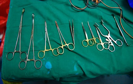 A set of tools on a green fabric that are used during female genital mutilation
