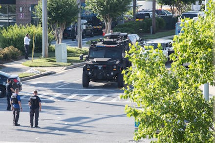An armored police vehicle driving down a road in America
