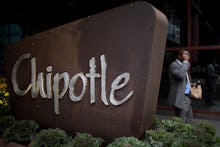 A man walking past a large Chipotle sign in Pennsylvania