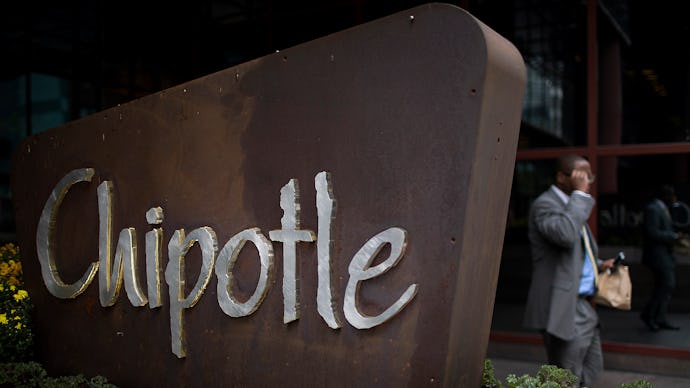 A man walking past a large Chipotle sign in Pennsylvania