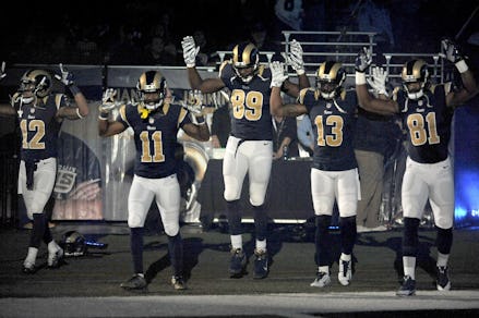 The St. Louis Rams players performing the tunnel bearing the "hands up, don't shoot" pose 