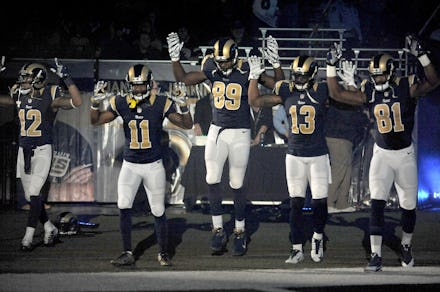 The St. Louis Rams players performing the tunnel bearing the "hands up, don't shoot" pose
