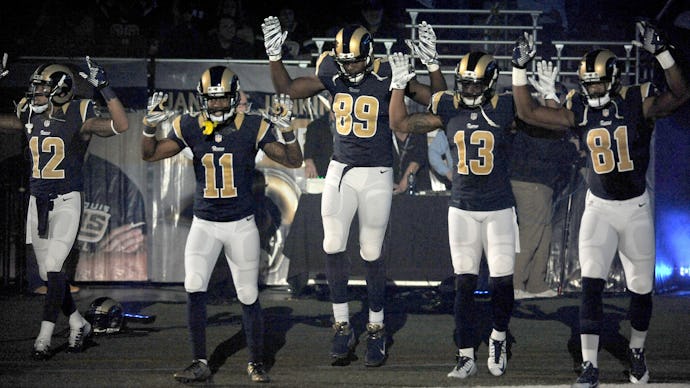 The St. Louis Rams players performing the tunnel bearing the "hands up, don't shoot" pose 