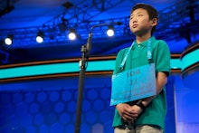 Contestant of the Scripps National Spelling Bee standing on the stage with his number on