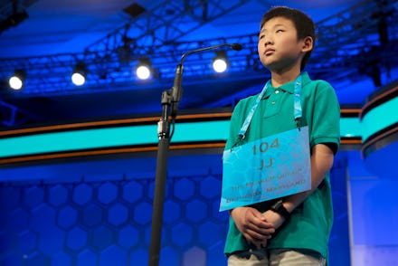 Contestant of the Scripps National Spelling Bee standing on the stage with his number on