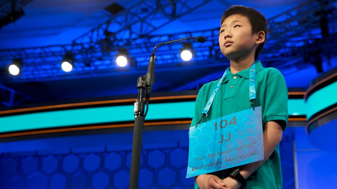 Contestant of the Scripps National Spelling Bee standing on the stage with his number on