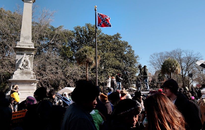 The Confederate flag in front of a large group of people on the one-year anniversary of the Charlest...