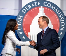 Ben McAdams and Mia Love shake hands in front of the utah debate commission
