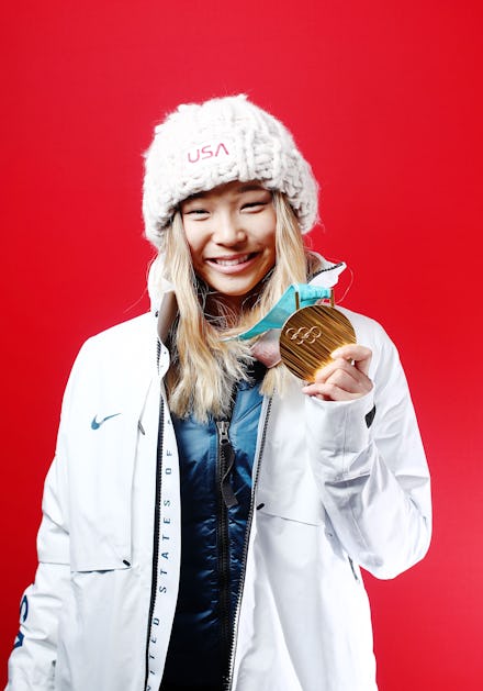 Chloe Kim holding her Olympic gold medal