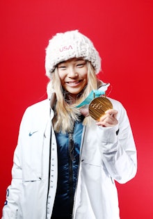 Chloe Kim holding her Olympic gold medal