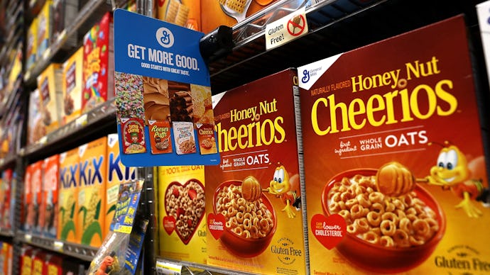 Shelves in a store with Cheerios on them 