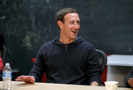 Mark Zuckerberg sitting at a desk in a black hoodie 