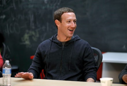 Mark Zuckerberg sitting at a desk in a black hoodie